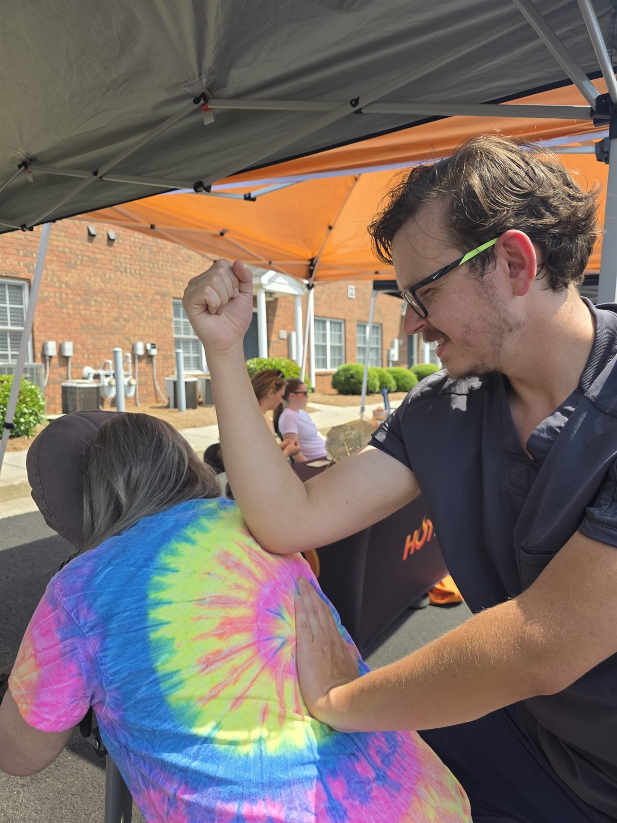 The People's Elbow giving chair massage at the Rock the Block Party